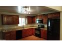Updated kitchen featuring granite countertops, stainless steel appliances, and wood cabinets at 1009 E Hampton Ave, Mesa, AZ 85204