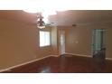 Inviting living room with hardwood floors, ceiling fan, and plenty of natural light at 1009 E Hampton Ave, Mesa, AZ 85204