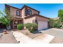 Charming two-story home with desert landscaping and a two-car garage at 1017 W Lydia Ln, Phoenix, AZ 85041