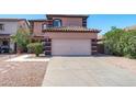 Inviting two-story home featuring a desert landscape and a two car garage at 1017 W Lydia Ln, Phoenix, AZ 85041