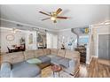 Spacious living room featuring modern decor, ceiling fan and wood-look floors at 1017 W Lydia Ln, Phoenix, AZ 85041