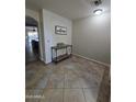 Inviting foyer features tiled flooring, a decorative console table and stylish decor at 1309 E Julie Ct, San Tan Valley, AZ 85140