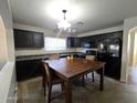 The kitchen features a table, tiled floor, and dark cabinets at 1309 E Julie Ct, San Tan Valley, AZ 85140