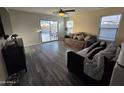 Cozy living room with hardwood floors, sliding glass doors to the backyard, and lots of natural light at 1309 E Julie Ct, San Tan Valley, AZ 85140