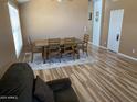 Inviting dining room featuring wood-look floors, modern table set, and natural light at 1417 E Century Ave, Gilbert, AZ 85296