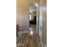 Inviting hallway showcasing wood-look flooring leading to living spaces with neutral wall colors at 1417 E Century Ave, Gilbert, AZ 85296