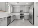 Well-lit kitchen with stainless steel appliances, grey cabinets, and stylish countertops, perfect for cooking at 14870 W Encanto Blvd # 1059, Goodyear, AZ 85395