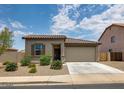 Charming single-story home featuring a well-maintained front yard with desert landscaping and an attached garage at 1630 E Prickly Pear Pl, Casa Grande, AZ 85122