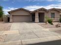 Charming single-story home featuring a well-manicured front yard and attached two-car garage at 16526 W Calle Lejos --, Surprise, AZ 85387