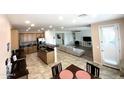 Expansive open-concept kitchen with stainless steel appliances, tile floors, and modern design at 16526 W Calle Lejos --, Surprise, AZ 85387