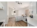 Bright kitchen features white cabinets, quartz countertops, and stainless steel sink at 16827 S 20Th Way, Phoenix, AZ 85048