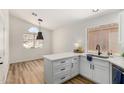 Bright kitchen features white cabinets, quartz countertops, and stainless steel sink at 16827 S 20Th Way, Phoenix, AZ 85048