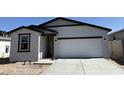 Attractive single-story home featuring a spacious driveway and an inviting facade at 18243 W La Senda Dr, Surprise, AZ 85387