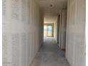 A hallway with gray walls and concrete floor leads to a room with sliding glass doors at 18260 W Camino De Oro --, Surprise, AZ 85387