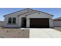 Charming single-story home featuring a stucco facade, two-car garage and low maintenance desert landscaping at 18261 W Camino De Oro --, Surprise, AZ 85387