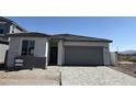 Modern single-story home with a two-car garage and low maintenance front yard at 18271 W La Senda Dr, Surprise, AZ 85387