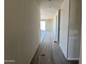 Hallway showing tile floors, neutral walls, and an open-concept layout at 18272 W Camino De Oro --, Surprise, AZ 85387