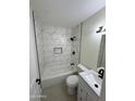 Modern bathroom featuring a new bathtub with white marble tile surround, a new toilet, and vanity at 18629 N 4Th Dr, Phoenix, AZ 85027