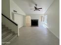 Spacious living room featuring a fireplace, neutral walls, tile flooring, and modern ceiling fan at 18629 N 4Th Dr, Phoenix, AZ 85027