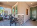 Inviting front porch with stone accents, seating, and views of the neighborhood at 20641 W College Dr, Buckeye, AZ 85396