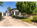 Home featuring a front porch, a basketball hoop in the driveway, and desert landscaping at 2221 N Richland St, Phoenix, AZ 85006