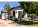 Cozy home with a front porch, desert landscaping, and a basketball hoop in the driveway at 2221 N Richland St, Phoenix, AZ 85006