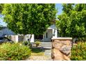 Inviting home with lush landscaping, a stone pillar, and a well-manicured lawn at 2221 N Richland St, Phoenix, AZ 85006