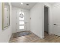 Bright entryway with modern door, wood-look tile flooring, and clean, neutral decor at 26943 N 74Th Ave, Peoria, AZ 85383