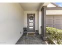 Inviting front porch with neutral colors, a decorative wreath, and a charming doormat at 26943 N 74Th Ave, Peoria, AZ 85383