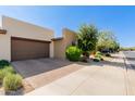 View of the exterior and garage, showcasing a desert landscape with an enclosed garage at 35990 N Desert Tea Dr, Queen Creek, AZ 85140