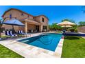 Inviting backyard featuring a pool, covered patio seating and a grassy yard at 3760 W Lapenna Dr, New River, AZ 85087