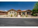 Charming single-story home with desert landscaping, stone accents, and a tiled walkway to the front door at 41809 N La Crosse Trl, Anthem, AZ 85086