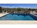 Backyard pool with travertine tile and water feature with desert views at 41809 N La Crosse Trl, Anthem, AZ 85086