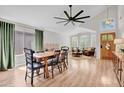 Dining area with high ceilings, modern fan, and access to seating area creates open floor plan at 4350 E Gatewood Dr, Phoenix, AZ 85050
