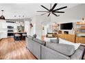 Living room with high ceilings, large TV, and view of the kitchen island make an airy and open design at 4350 E Gatewood Dr, Phoenix, AZ 85050