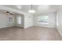 Bright and airy living room with tile floors, neutral paint, and ample natural light at 445 W 1St St, Mesa, AZ 85202