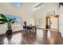 Bright dining room with vaulted ceilings, wood floors, and plenty of natural light at 45311 W Woody Rd, Maricopa, AZ 85139