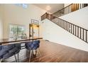 Open-concept foyer featuring high ceilings, wood floors, and a staircase to the upper level at 45311 W Woody Rd, Maricopa, AZ 85139