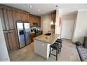Well-equipped kitchen boasts a large island with seating, stainless steel appliances, and ample cabinetry at 5345 E Van Buren St # 115, Phoenix, AZ 85008