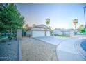 Attractive single-story home with a two-car garage, desert landscaping, and a circular driveway at 836 N Sinova Ave, Gilbert, AZ 85234