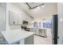 Modern kitchen featuring sleek countertops, stainless steel appliances, and ample cabinet space at 836 N Sinova Ave, Gilbert, AZ 85234