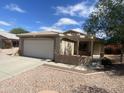 Charming home featuring a tile roof, two-car garage, and low maintenance front yard landscaping at 8738 W Griswold Rd, Peoria, AZ 85345