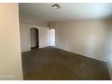 A light and airy living room with neutral paint and carpet, and an archway leading to other rooms at 8738 W Griswold Rd, Peoria, AZ 85345