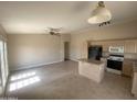 Open-concept living and kitchen area with tile floors and a center island, great for modern living at 8738 W Griswold Rd, Peoria, AZ 85345