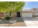 Charming single-story home showcasing a well-manicured front yard and a two-car garage at 8828 N 102Nd Ln, Peoria, AZ 85345