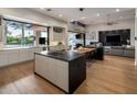 Modern kitchen featuring a large island, sleek white cabinetry, and seamless connection to the living room at 9148 N 66Th Pl, Paradise Valley, AZ 85253