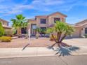 Charming two-story home featuring desert landscaping and an attached three-car garage at 981 N Quail Ln, Gilbert, AZ 85233