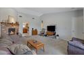 Cozy living room with brick fireplace and neutral carpeting at 1559 S Padre Rd, Apache Junction, AZ 85119