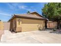 Single-story home featuring a spacious two-car garage, desert landscaping, and a light-colored exterior, perfect for easy access at 16441 N 138Th Ave, Surprise, AZ 85374