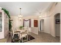 Cozy dining area featuring chandelier lighting, tiled floors, and neutral paint at 17585 N Coyote Lakes Pkwy, Surprise, AZ 85378